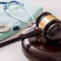 Gavel and stethoscope in background. Medical laws and legal concept. Gavel and stethoscope in background. Medical laws and legal concept.